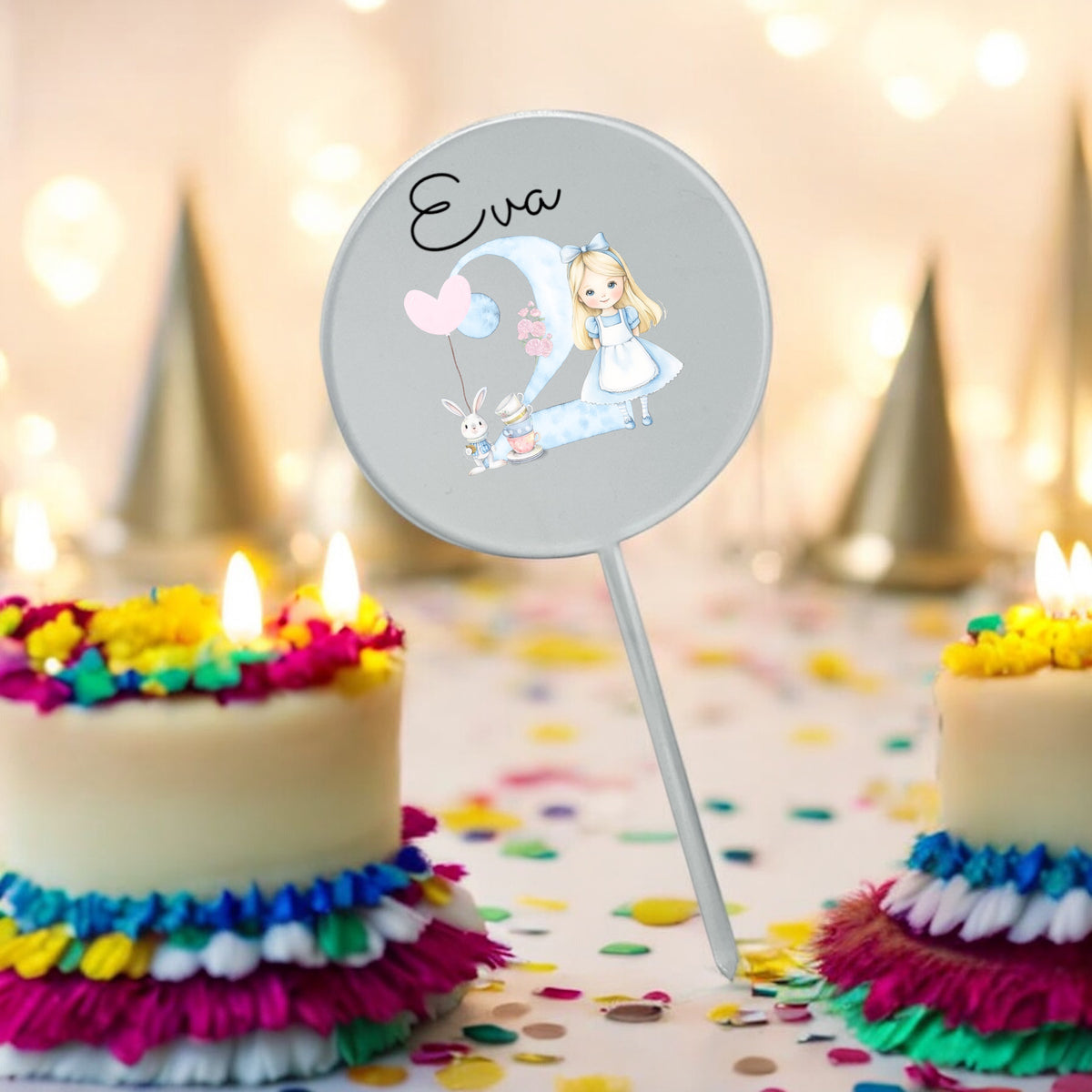 A personalised cake topper with a character illustration and the name 'Alice' written on it, placed on top of a colorful cake with lit candles in the background.