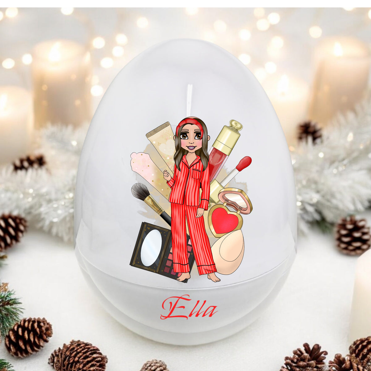 A decorated white egg with a personalized message and illustration of a character in pajamas surrounded by various items, such as makeup and a toy camera, with the name 'Ella' on the egg.