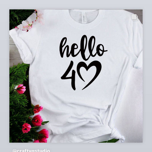 A white T-shirt with the text 'Hello' and a heart shape, indicating a birthday celebration T-shirt.