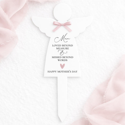 White dress with pink bow and Mother's Day message on a soft pink background