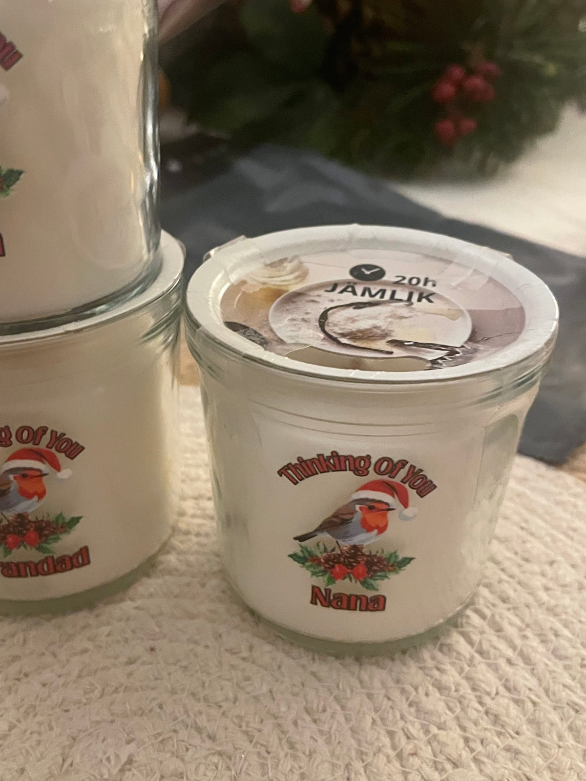 Two containers with a brand logo on a textured surface
