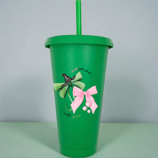 Green tumbler with decorative bows and text on a light gray background